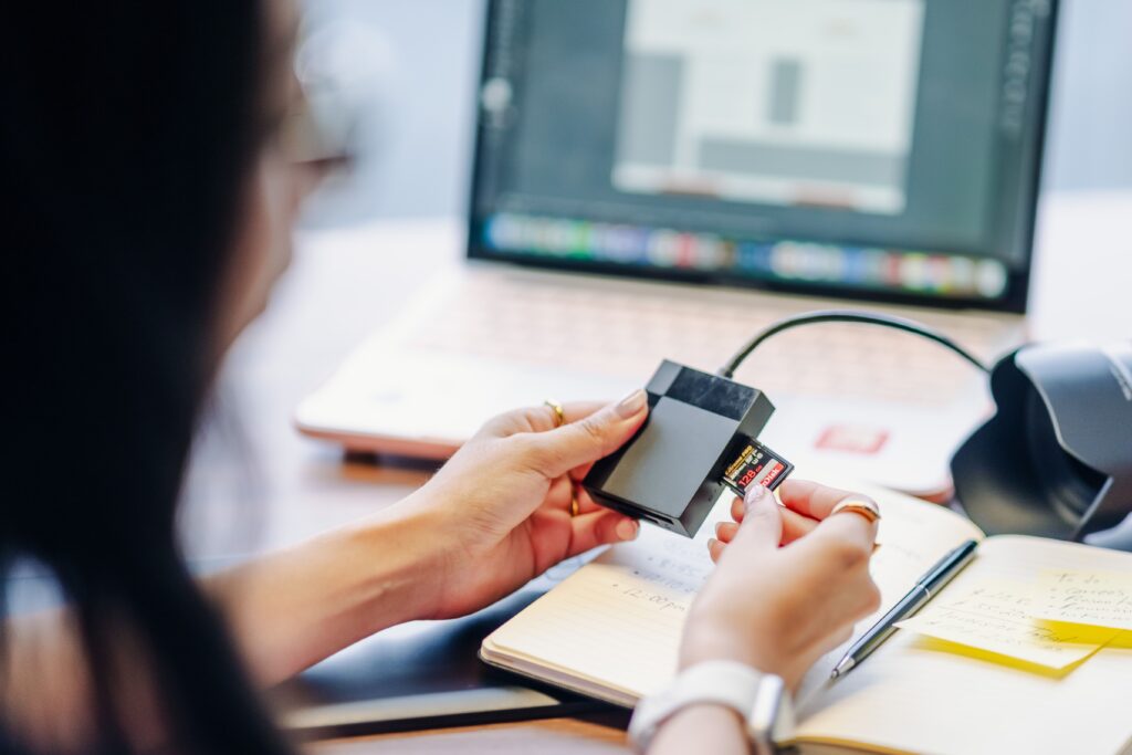 Digital media being transferred from storage into a laptop workflow
