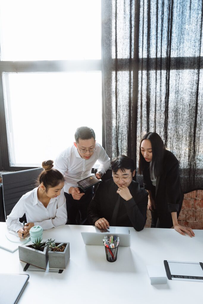 Professional team collaborating around a laptop on a managed website project
